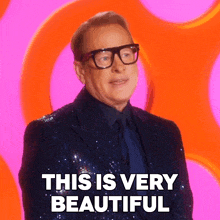 a man with glasses and a suit says this is very beautiful