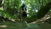 a man in a stout jersey is holding a trident in the woods
