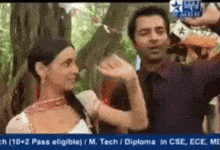 a man and a woman are standing next to each other in front of a sign that says diploma in cse ece me