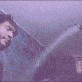 a blurry picture of a person holding a purple cloth