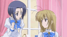 two anime girls are standing in front of a window