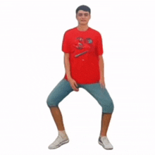 a man in a red shirt and blue shorts is doing squats on a white background .