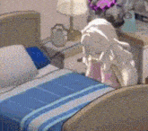 a girl with white hair is sitting on a bed with a blue blanket .