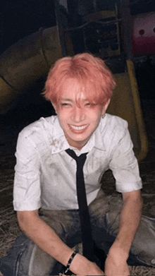 a young man with pink hair wearing a white shirt and black tie