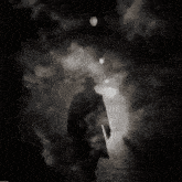 a man in a hat walks through a tunnel