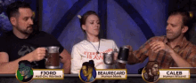 a group of people sitting at a table with a woman wearing a shirt that says everything is aw