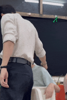 a man in a white shirt and black pants is standing next to another man in a blue shirt that says always