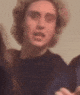 a close up of a man 's face with a blurred background .