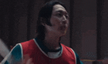 a man in a red and blue sweater with the letter da on it