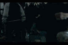 a man is touching a woman 's hair in a dark room .