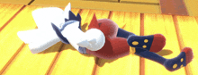 a couple of stuffed animals laying on a wooden floor