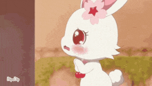 a white rabbit with a pink flower on its head is crying and looking at something .