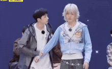 a man in a blue jacket has a name tag on his chest that says ' a '
