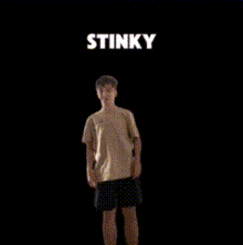 a man is standing in front of a black background with the word stinky written above him