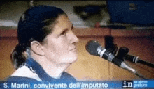 a woman is speaking into a microphone with the words s. marini convincente dell ' imputato written below her
