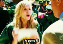 a woman says a pony while talking to a man in a crowd