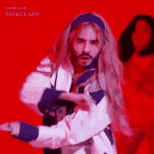 a man with long blonde hair and a beard is dancing .