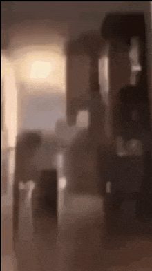 a blurry picture of a living room with a couch and a chair .