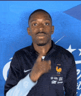 a man wearing a nike jacket with a rooster on the front