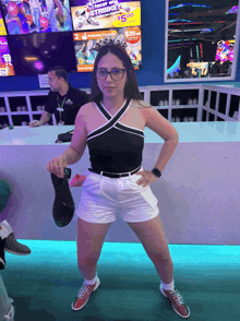 a woman standing in front of a bowling alley with a sign that says strike