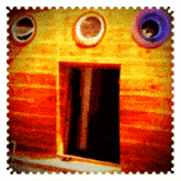 a picture of a wooden house with a cat in a window