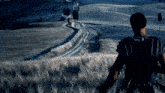 a person standing in a field with a sign that says no parking