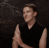 a man clapping his hands in front of a dragon sign
