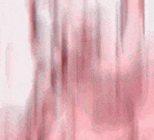 a close up of a person 's hand against a pink background .