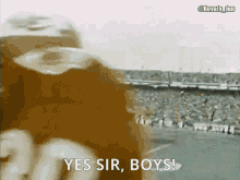 a football player says " yes sir boys " in front of a stadium