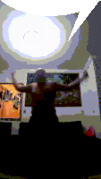 a person is dancing in a dark room with a picture on the wall that says ' i love you ' on it