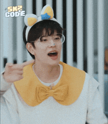 a boy wearing a headband with bunny ears and a bow tie screams