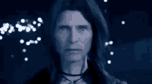 a close up of a person 's face in a dark room with lights coming out of it .