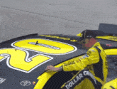 a man is working on a race car that says dollar general on it