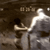 a blurred image of a man and a woman with the numbers 03 26 76 on the bottom