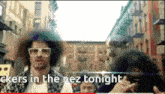 a man with a afro and sunglasses says " ckers in the nez tonight " in a video