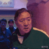a man in a green jacket has the number 336 on his jacket