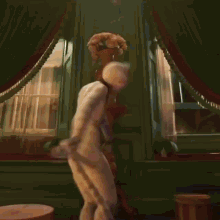 a man dressed as a cat is dancing with his arms outstretched
