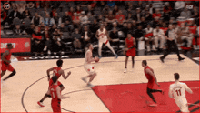 a basketball game is being played in front of a toyota banner