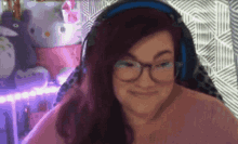 a woman wearing glasses and headphones is making a face