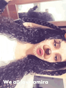 a woman with a mask on her face and the words we all love amira on the bottom