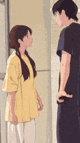 a man and a woman are standing next to each other and looking at each other