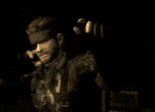 a man with a shaved head is holding a gun in a dark room