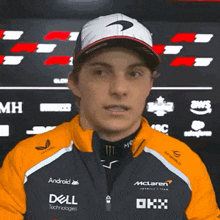 a man wearing a mclaren jacket and a dell jacket