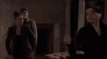 a man in a hat is holding a woman in a room .