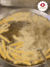french fries are being cooked in a pan with a choore sticker on the bottom