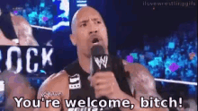 a man speaking into a microphone with the words " you 're welcome bitch "