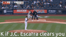 a baseball game is being played in front of a banner for maxxis