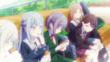 a group of anime girls sit on a bench eating food