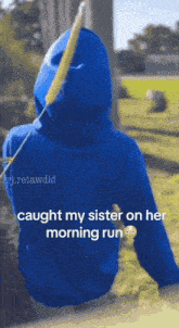 a person wearing a blue hoodie with the words caught my sister on her morning run on it