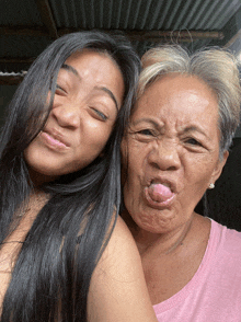 a young girl and an older woman make funny faces